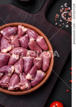 Fresh raw chicken or turkey hearts in a ceramic plate with salt, spices and herbs Fresh raw chicken or turkey hearts in a ceramic plate with salt, spices and herbs 105924126