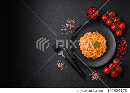 Delicious fresh pasta consisting of thin noodles, red pesto rosso sauce with spices and herbs Delicious fresh pasta consisting of thin noodles, red pesto rosso sauce with spices and herbs 105924178