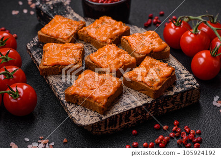 Delicious sandwich consisting of toast, red sauce with salt, spices and herbs Delicious sandwich consisting of toast, red sauce with salt, spices and herbs 105924192