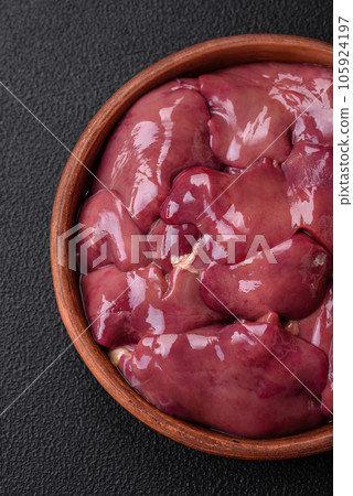 Fresh raw chicken or turkey liver in a ceramic plate with salt, spices and herbs Fresh raw chicken or turkey liver in a ceramic plate with salt, spices and herbs 105924197