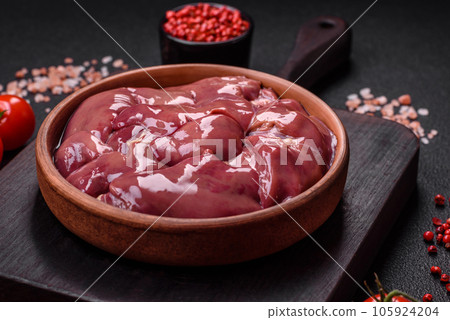 Fresh raw chicken or turkey liver in a ceramic plate with salt, spices and herbs Fresh raw chicken or turkey liver in a ceramic plate with salt, spices and herbs 105924204