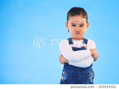 Angry, child and arms crossed with tantrum in studio with mockup space. Kid, young girl and frustrated with cross frown and pout with a problem and mad attitude with blue background and grumpy Angry, child and arms crossed with tantrum in studio with mockup space. Kid, young girl and frustrated with cross frown and pout with a problem and mad attitude with blue background and grumpy 105924382