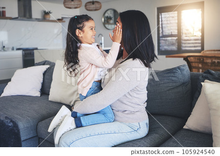 Touch, happy and playful with mother and daughter on sofa for love, care and support. Funny, calm and relax with woman and young girl embrace in living room of family home for peace, cute and bonding 105924540