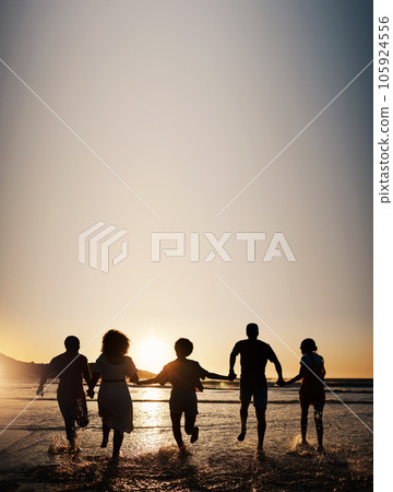 Sunset, water splash and friends holding hands at a beach with freedom, running or fun on summer vacation. Ocean, silhouette and people shadow in solidarity at the sea for travel, bond or celebration Sunset, water splash and friends holding hands at a beach with freedom, running or fun on summer vacation. Ocean, silhouette and people shadow in solidarity at the sea for travel, bond or celebration 105924556
