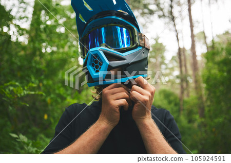 Helmet, hands and person in forest, cycling outdoor and safety with adventure and fitness. Protection, gear and travel, athlete and extreme sports with exercise, training and challenge with biking Helmet, hands and person in forest, cycling outdoor and safety with adventure and fitness. Protection, gear and travel, athlete and extreme sports with exercise, training and challenge with biking 105924591