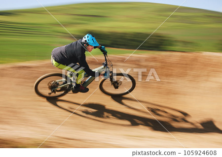 Bicycle, man and cycling in motion blur on dirt path for competition, fast power and off road adventure. Athlete, sports and mountain bike for action, cardio race and speed in performance contest Bicycle, man and cycling in motion blur on dirt path for competition, fast power and off road adventure. Athlete, sports and mountain bike for action, cardio race and speed in performance contest 105924608