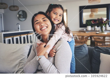 Hug, smile and portrait of mother and daughter on sofa for love, care and support. Happy, calm and relax with woman and young girl embrace in living room of family home for peace, cute and bonding 105924622