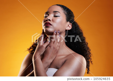 Beauty, makeup and curly hair with face of woman in studio for texture, fashion and cosmetics. Self care, salon and hairstyle with model on orange background for skincare, spa treatment and mockup 105924635