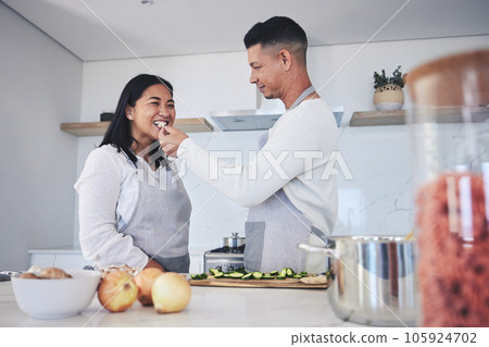 Feeding, cooking and love with couple in kitchen for food, health and lunch recipe. Happy, nutrition and dinner with man and woman cutting vegetables at home for diet, wellness and romance together Feeding, cooking and love with couple in kitchen for food, health and lunch recipe. Happy, nutrition and dinner with man and woman cutting vegetables at home for diet, wellness and romance together 105924702