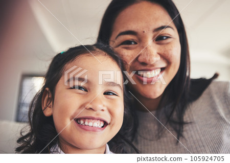 Selfie, smile and portrait of a girl with her mother bonding in the living room of their home. Happy, love and face headshot of Asian child taking a picture with her young mom at their family house. Selfie, smile and portrait of a girl with her mother bonding in the living room of their home. Happy, love and face headshot of Asian child taking a picture with her young mom at their family house. 105924705