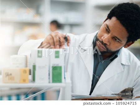 Black man, pharmacist and check stock, drugs and health, prescription medicine and supplements in pharmacy. Organize inventory, healthcare and medical, hospital dispensary and pharmaceutical pills 105924715