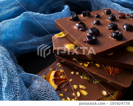 Pieces of chocolate. With berries, strawberries, oranges. 105924739