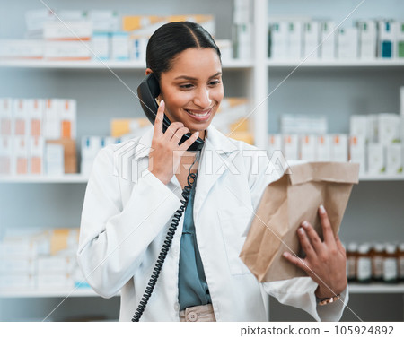 Phone call, pharmacy and woman with package for medicine, prescription and medication collection. Healthcare, medical care and happy pharmacist speaking for telehealth, consultation and order service Phone call, pharmacy and woman with package for medicine, prescription and medication collection. Healthcare, medical care and happy pharmacist speaking for telehealth, consultation and order service 105924892