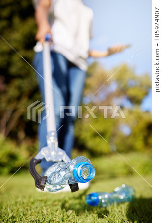 Park, pollution and closeup for cleaning, plastic bottle and and tools for climate change in nature. Person, garbage or trash on grass with help for environment, forest or earth with sustainability Park, pollution and closeup for cleaning, plastic bottle and and tools for climate change in nature. Person, garbage or trash on grass with help for environment, forest or earth with sustainability 105924907