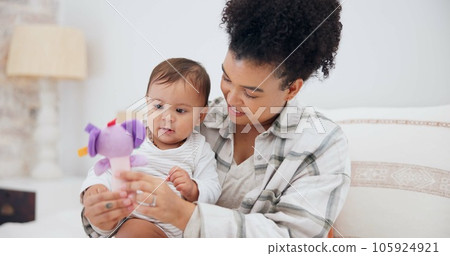 Mother, baby or child with a toy at home for development and growth. Cute toddler or infant kid playing with a woman or parent for love, care and security while learning mobility in a family bedroom 105924921