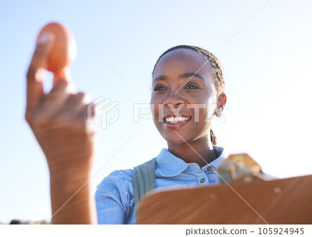 Woman, quality and egg in hand on farm with clipboard outside for sustainable small business in Africa. Poultry farming inspection, checklist and happy black farmer in countryside with sky and smile. 105924945