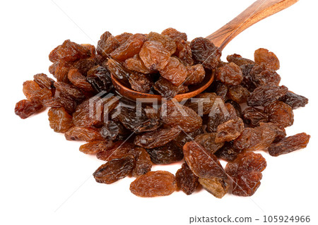 Spoon with raisins on a bunch of raisins over a white background. 105924966