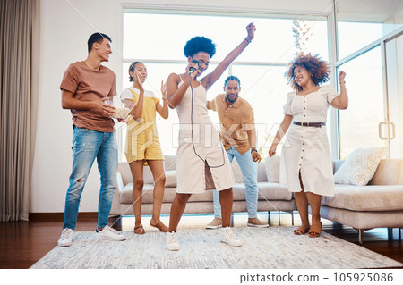 Sing, energy and friends dancing in the living room with a microphone to music, playlist or radio. Happy, diversity and young people moving, bonding and having fun together with karaoke at home. Sing, energy and friends dancing in the living room with a microphone to music, playlist or radio. Happy, diversity and young people moving, bonding and having fun together with karaoke at home. 105925086