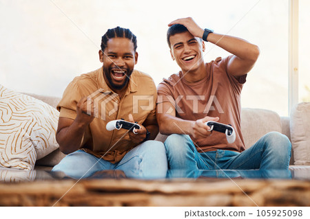 Men on sofa playing video game, excited fun and relax in home living room together on internet with controller. Online gaming, esports and happy gamer friends on couch with virtual app in apartment. 105925098