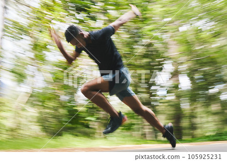 Running, fitness and blur of man in forest for marathon training, exercise and cardio workout. Sports, race and athlete with speed for wellness, performance and endurance for challenge in nature 105925231