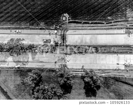 Overhead view of road construction on a partitioned road with tracked dirt.  105926133