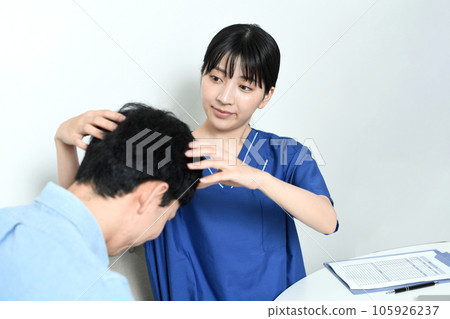 A doctor and a male patient who diagnose thinning hair treatment A doctor and a male patient who diagnose thinning hair treatment 105926237