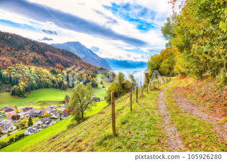 Astonishing autumn view on suburb of Hergiswil village with mountaines and fog. Astonishing autumn view on suburb of Hergiswil village with mountaines and fog. 105926280
