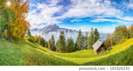 Outstanding autumn view on suburb of Stansstad city  and Lucerne lake with mountaines and fog. 105926293