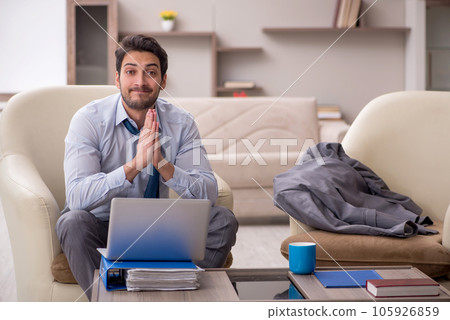 Young male employee working from home 105926859