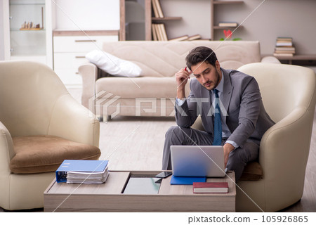Young male employee working from home 105926865
