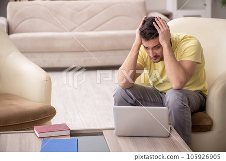 Young man working from home during pandemic Young man working from home during pandemic 105926905