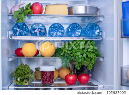 Open fridge full of fresh fruits and vegetables, vegetarian food healthy food background, greenery, organic nutrition, health care, dieting concept 105927005