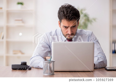 Young male employee working in the office 105927169
