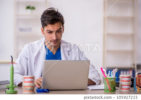 Young male dentist working in the clinic 105927215