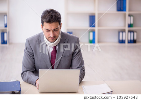 Young male employee after car accident sitting in the office Young male employee after car accident sitting in the office 105927548