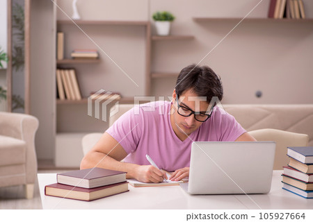Young male student preparing for exams at home 105927664