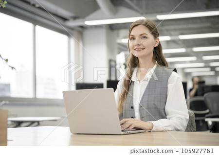 Foreign businesswoman smiling looking at camera Foreign businesswoman smiling looking at camera 105927761