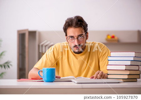 Young male student preparing for exams at home Young male student preparing for exams at home 105927870