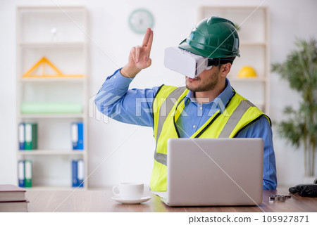 Young male architect wearing virtual glasses 105927871