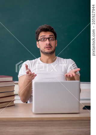 Young male student sitting in the classroom 105927944
