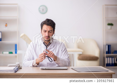 Young male doctor working in the clinic Young male doctor working in the clinic 105927981