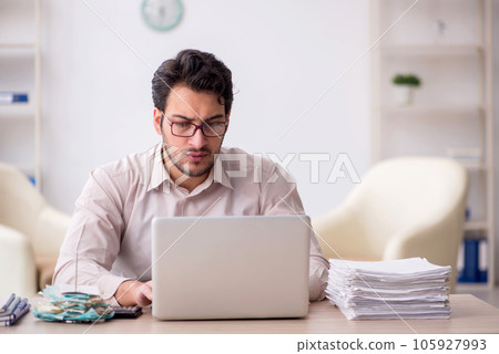 Young male accountant working in the office Young male accountant working in the office 105927993