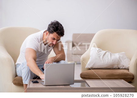 Young man starting day at home 105928270