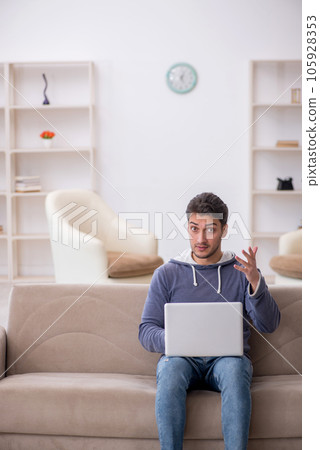 Young male freelancer working from home 105928353