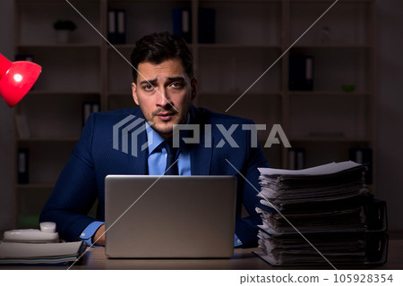 Young male employee working late in the office 105928354