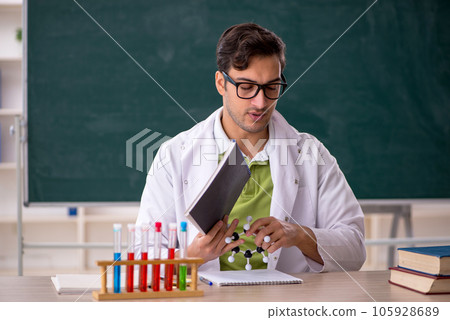 Young male chemist in the classroom 105928689