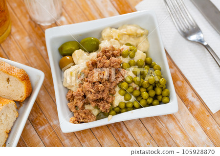 Banquet in restaurant - Spanish salad with potatoes, tuna, olives and egg 105928870