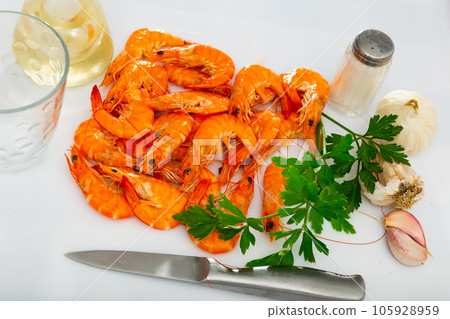 Seafood appetizer. Roasted langostins served with parsley 105928959