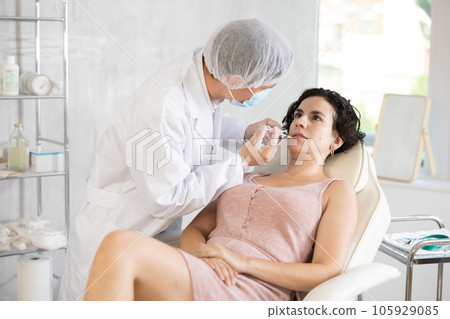 Facial injection female patient 105929085