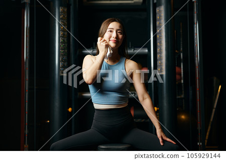 Woman wiping off sweat during workout 105929144